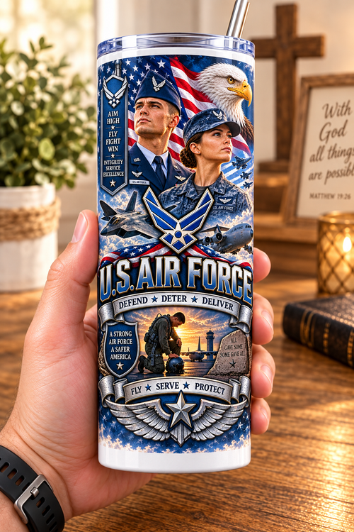 Hand holding a straight-sided 20 oz tumbler with Patriotism Air Force 2 artwork on a warm wood counter