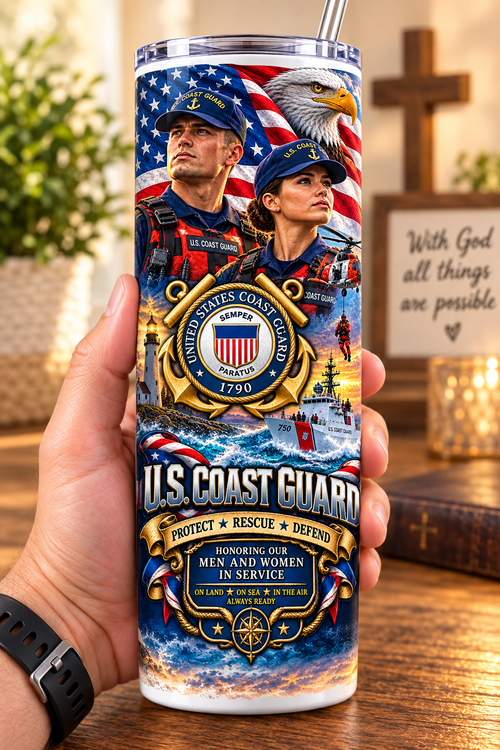 Hand holding a straight-sided 20 oz tumbler with Patriotism Coast Guard 1 artwork on a warm wood counter