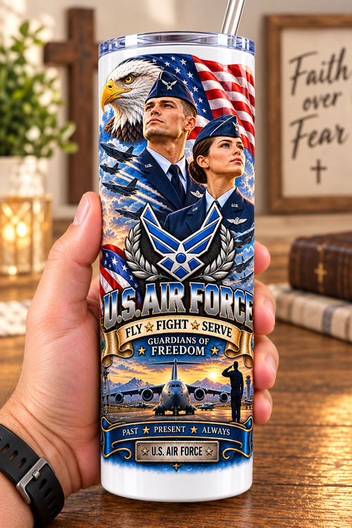 Hand holding a straight-sided 20 oz tumbler with Patriotism Air Force 1 artwork on a warm wood counter