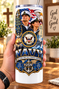 Hand holding a straight-sided 20 oz tumbler with Patriotism Navy 3 artwork on a warm wood counter